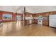 Open concept kitchen with hardwood floors, white appliances, and natural wooden cabinets at 6231 Prospect Rd, Longmont, CO 80503