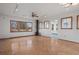 Bright living room with wood floors, a red fireplace, and many windows for natural light at 6231 Prospect Rd, Longmont, CO 80503