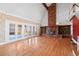Bright living room featuring hardwood floors, a brick fireplace, and large sliding doors offering scenic outdoor views at 6231 Prospect Rd, Longmont, CO 80503