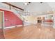 Open-concept living space with hardwood floors, a staircase leading to an upper level, and views into the kitchen area at 6231 Prospect Rd, Longmont, CO 80503