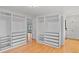 Bright main bedroom featuring custom closets and drawers, plus gleaming hardwood floors at 6231 Prospect Rd, Longmont, CO 80503