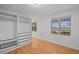 Bright main bedroom featuring custom closets and drawers, plus gleaming hardwood floors at 6231 Prospect Rd, Longmont, CO 80503