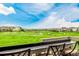 An incredible golf course view awaits from the back porch seating area on a bright day at 27375 E Alder Dr, Aurora, CO 80016