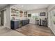 The basement bar features blue cabinets, wood floor and shelving at 27375 E Alder Dr, Aurora, CO 80016