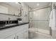 Modern bathroom featuring a sleek vanity with a black countertop and a spacious glass-enclosed shower at 27375 E Alder Dr, Aurora, CO 80016