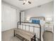 Clean guest bedroom featuring a cozy bed, ceiling fan, and a wooden bench at the foot of the bed at 27375 E Alder Dr, Aurora, CO 80016