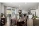 Open dining area showcases hardwood floors and seamless flow to the living room and outdoor patio at 27375 E Alder Dr, Aurora, CO 80016