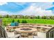 Outdoor fire pit area with stone seating and views of the neighborhood at 27375 E Alder Dr, Aurora, CO 80016