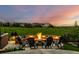 Inviting outdoor fire pit area with seating, perfect for entertaining and enjoying the scenic views at 27375 E Alder Dr, Aurora, CO 80016