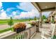Relaxing front porch featuring beautiful flower boxes and an open view of the neighborhood and lush green spaces at 27375 E Alder Dr, Aurora, CO 80016