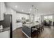 Modern kitchen with a large island, granite countertops, and stainless steel appliances at 27375 E Alder Dr, Aurora, CO 80016