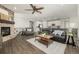 Open living room featuring a stone fireplace, hardwood floors, and plenty of seating at 27375 E Alder Dr, Aurora, CO 80016