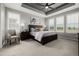 Serene main bedroom with tray ceiling, large windows, and neutral tones, offering a relaxing retreat at 27375 E Alder Dr, Aurora, CO 80016