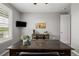 The home office has a large desk, view to the outside, neutral carpet and a mounted tv at 27375 E Alder Dr, Aurora, CO 80016