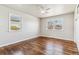 Serene bedroom with hardwood floors, two large windows providing natural light, and closet for storage at 1665 Yukon St, Lakewood, CO 80214