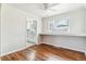 Cozy dining area with hardwood floors and a large window offering a view of the beautifully renovated kitchen at 1665 Yukon St, Lakewood, CO 80214