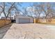 Detached garage with a paved driveway and fencing around the yard at 1665 Yukon St, Lakewood, CO 80214