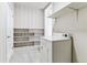 Cozy laundry room with washer, dryer, built-in shelves, and storage space at 1665 Yukon St, Lakewood, CO 80214