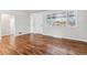 Bright living room featuring beautiful hardwood floors, fresh paint, and natural light from a large window at 1665 Yukon St, Lakewood, CO 80214