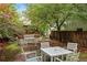 Serene backyard with mature trees, patio furniture, and a relaxing atmosphere at 3211 Zuni St # 14, Denver, CO 80211