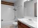 Bright bathroom featuring a tub with tiled surround, a sink with a vanity, and fixtures at 3211 Zuni St # 14, Denver, CO 80211