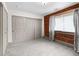 Bedroom featuring a brick wall, large closet, and cozy gray carpeting, offering ample storage at 3211 Zuni St # 14, Denver, CO 80211