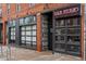 Brick building with black framed windows, a restaurant, and black accents at 3211 Zuni St # 14, Denver, CO 80211