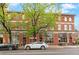 Beautiful three-story brick building with large windows and mature trees in front at 3211 Zuni St # 14, Denver, CO 80211