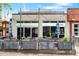 Restaurant exterior featuring outdoor patio seating, string lights, and a modern facade at 3211 Zuni St # 14, Denver, CO 80211