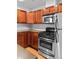 Kitchen featuring stainless steel appliances, wooden cabinets, and light wood floors at 3211 Zuni St # 14, Denver, CO 80211