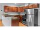Bright kitchen features stainless steel appliances, wooden cabinets, and light wood floors at 3211 Zuni St # 14, Denver, CO 80211