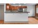 Open kitchen boasts wood cabinets, stainless steel appliances and breakfast bar at 3211 Zuni St # 14, Denver, CO 80211