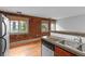Kitchen features stainless steel appliances, wooden cabinets, and exposed brick wall at 3211 Zuni St # 14, Denver, CO 80211