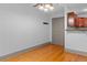 Living area with hardwood floors, gray trim and adjacent kitchen at 3211 Zuni St # 14, Denver, CO 80211