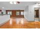 Living area with hardwood floors, brick wall and kitchen view at 3211 Zuni St # 14, Denver, CO 80211