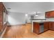 View of living room area shows hardwood floors and kitchen at 3211 Zuni St # 14, Denver, CO 80211