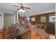 Cozy living space featuring hardwood floors, brick accent wall, and open kitchen at 3211 Zuni St # 14, Denver, CO 80211