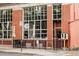 Charming restaurant exterior featuring large windows, outdoor seating, and a neighborhood library box at 3211 Zuni St # 14, Denver, CO 80211