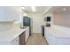 Well-lit kitchen with stainless appliances, white cabinets, and sleek countertops at 16820 Bitterbrush, Parker, CO 80134