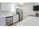 Bright kitchen features stainless steel appliances, white cabinetry, and a window above the sink at 16820 Bitterbrush, Parker, CO 80134