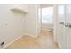 A laundry room with tile flooring, modern appliances, and ample cabinet space at 16820 Bitterbrush, Parker, CO 80134