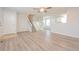 Spacious living area with modern vinyl floors, neutral paint, and access to the stairs at 16820 Bitterbrush, Parker, CO 80134