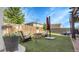 Well-kept backyard with artificial turf, a sitting area, and a privacy fence; great for outdoor entertaining at 7888 Tejon St, Denver, CO 80221