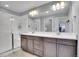 Modern bathroom with double vanity, large mirror, and a walk-in shower at 7888 Tejon St, Denver, CO 80221