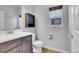 Small bathroom with white toilet and dark brown vanity at 7888 Tejon St, Denver, CO 80221