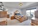 Bedroom featuring a bed with decorative wood frame, a window, and a bathroom ensuite at 7888 Tejon St, Denver, CO 80221