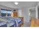 Comfortable bedroom with natural wood furniture, large windows, and blue quilt at 7888 Tejon St, Denver, CO 80221