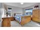Comfortable bedroom with natural wood furniture, large windows, and blue quilt at 7888 Tejon St, Denver, CO 80221
