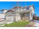 Two-story house with gray siding, brick accents, and a landscaped front yard at 7888 Tejon St, Denver, CO 80221