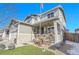 Two-story house with gray siding, brick accents, and a landscaped front yard at 7888 Tejon St, Denver, CO 80221